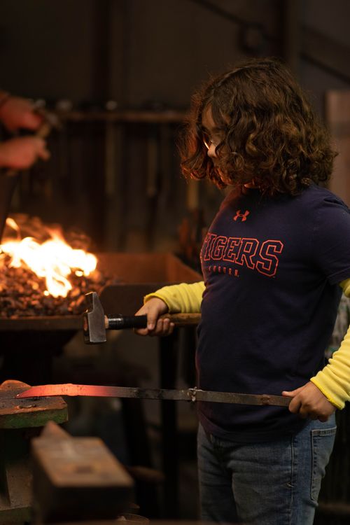 Grayton forging steel at blacksmithing