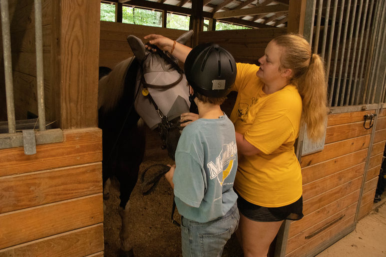 Mary, helping the boys tack up and get ready