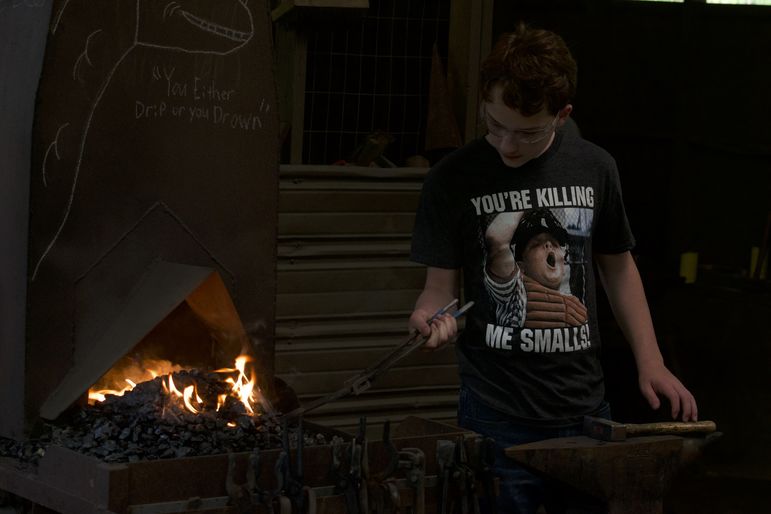 Luke manning the forge at the blacksmith shop