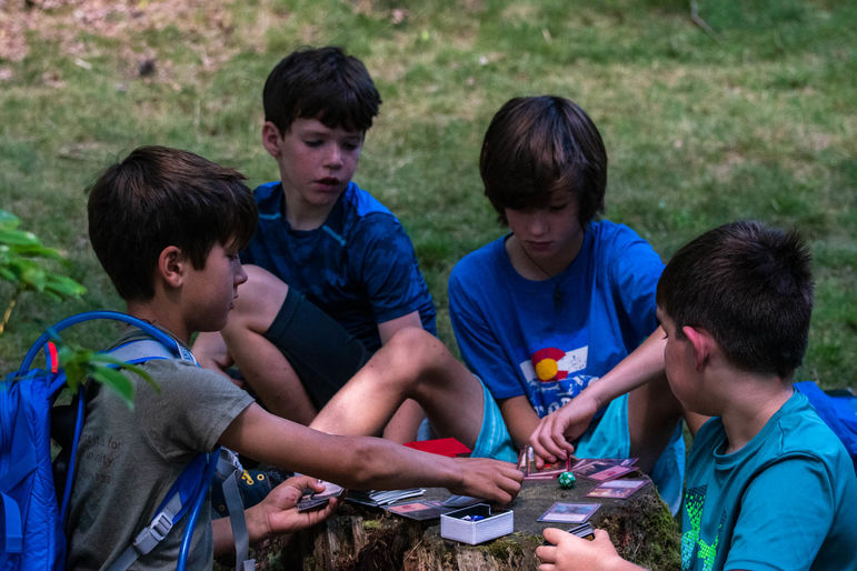 Using a tree stump as a Magic the Gathering card table