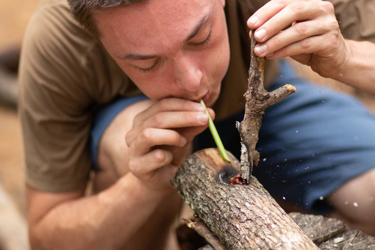 Learning friction fire drilling in Outdoor Skills Certified