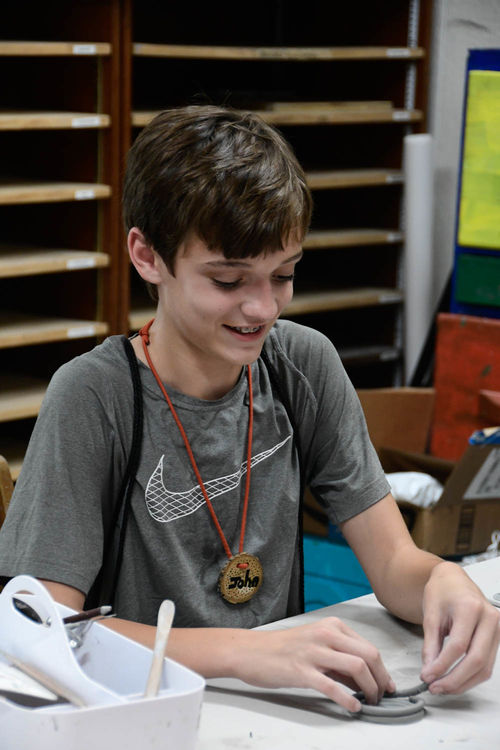 Working on coil pots in pottery
