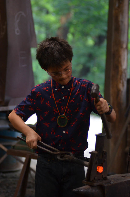 Henry manning the forge at blacksmithing