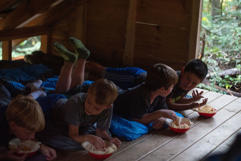 Enjoying dinner with friends on a Cabin Overnight