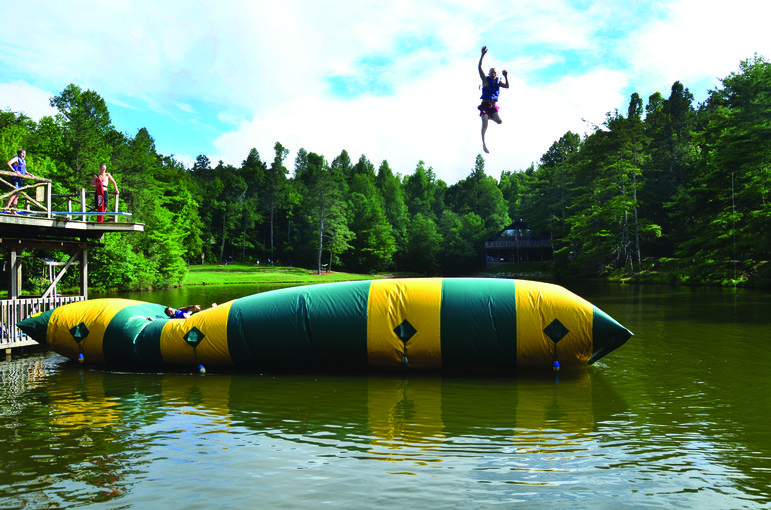 Campers enjoy the Blob at our camp swimming lake.