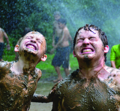 Camper and staff getting muddy in our camp mud pit.