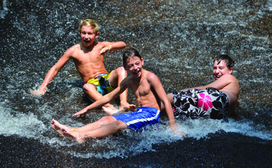 Campers enjoying Sliding Rock at Pisgah National Forest in North Carolina.