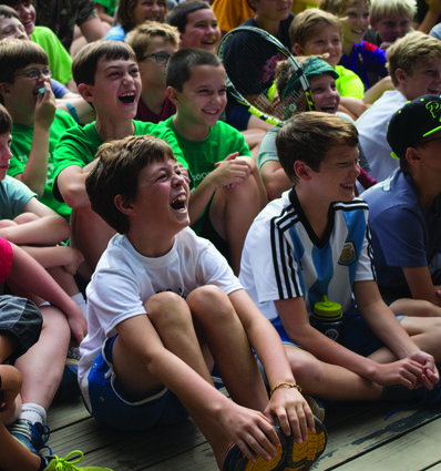 Campers have a laugh at our traditional morning assembly.