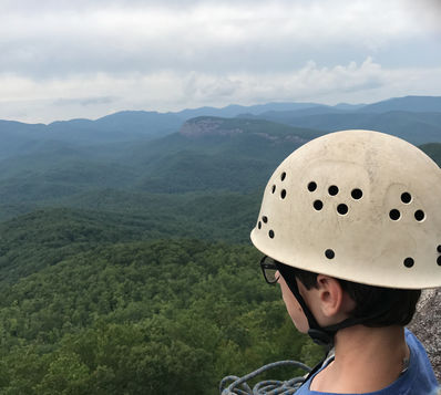 Camp climber looking out over Pisgah National Forest.