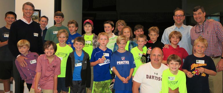 There was a great mix of returning campers and boys who came to learn more about FCC. Additionally, Ryan Tinch and Tom Madine, who were FCC campers years ago, brought their sons tonight. Emily Craft Broad, in the center of the back row, was a counselor in the late 80’s with Marisa, Yates, and Goody. She and Rick Broad met at camp and remained on staff through the mid 90’s. Their three sons are veteran campers and HUCK Expedition paddlers. John White, left, is returning to Father/Son weekend with his son John.