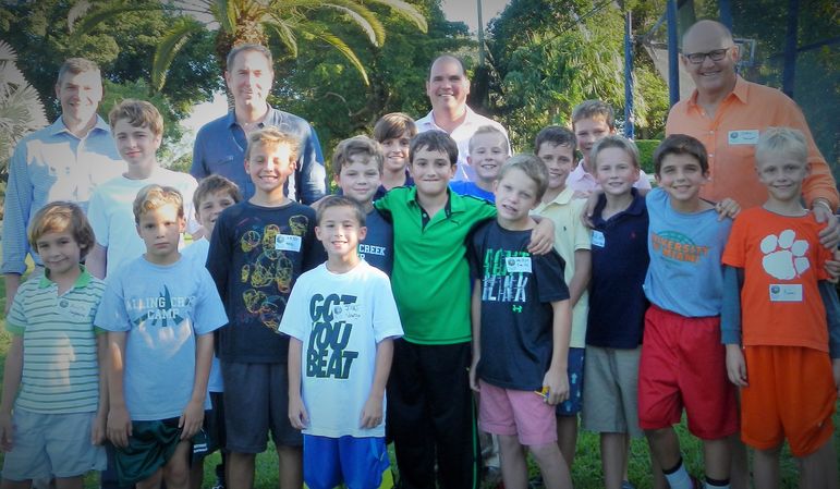 A large group of returning campers, boys who wanted to learn more about Falling Creek Camp, alumni, and dads who have attended Father/Son and Father/Daughter Weekends, stopped the ultimate frisbee game briefly to take their photo.