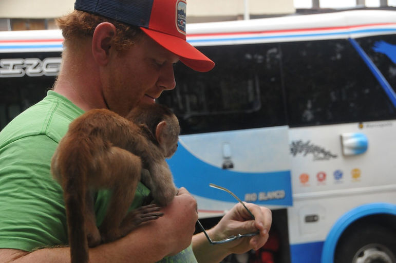 Ben meeting a monkey on the HUCK Ecuador paddling expedition scouting trip.