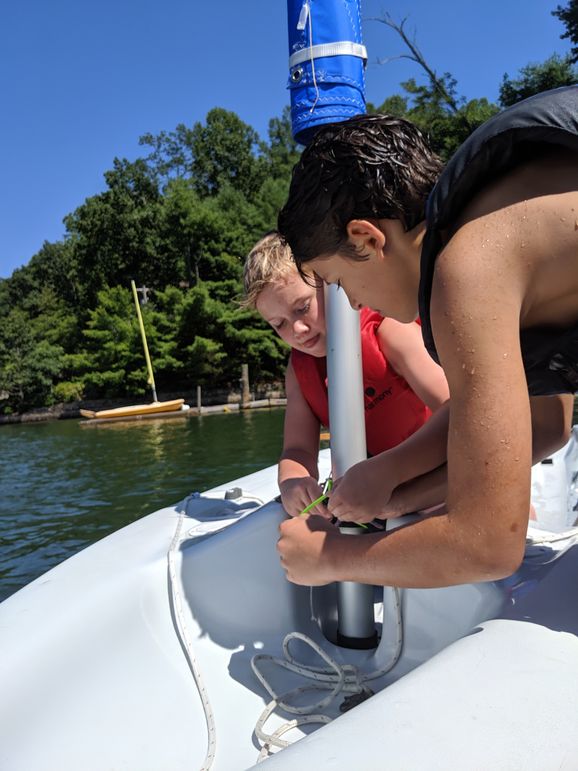 Phillips and Mac working together to rig their boat
