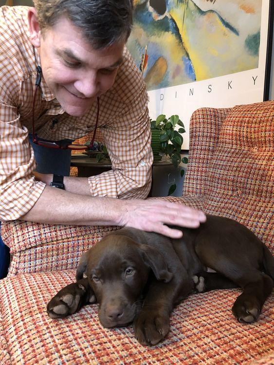 My dad making sure I’m all cozy for nap-time. Being a puppy is hard work!