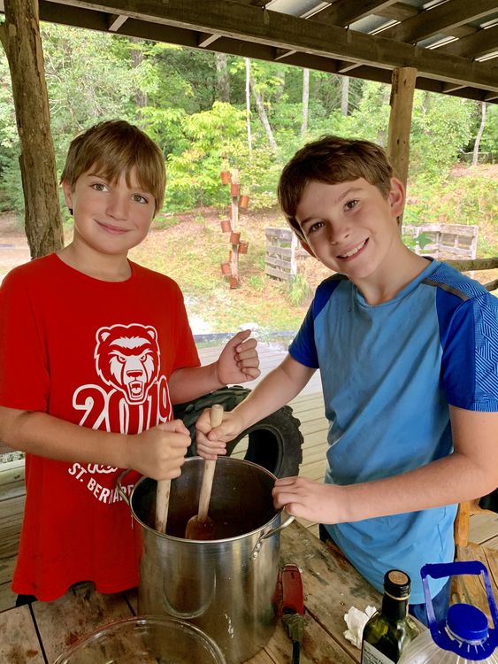 Preparing tomato sauce with the tomatoes they helped grow!