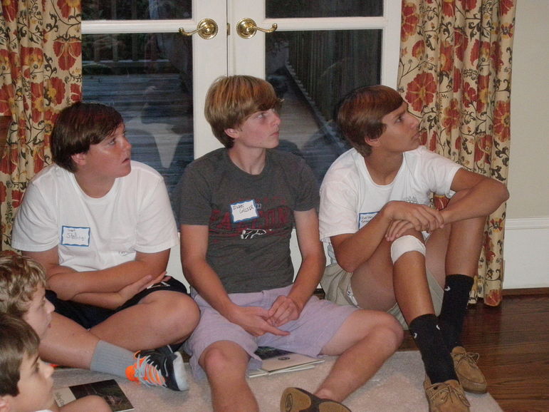 Long time FCC Campers Grant, Evans, and Harlan, enjoy their camp friendships while watching the FCC movie